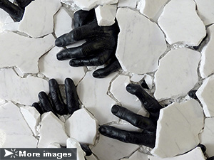 IZA, Isabelle Ardevol, woman contemporary artist, sculptress, art, Black blood under white skin, represents human black hands emerging from a see made of white marble blocks. Questions immigration, society and global warming, 2020.